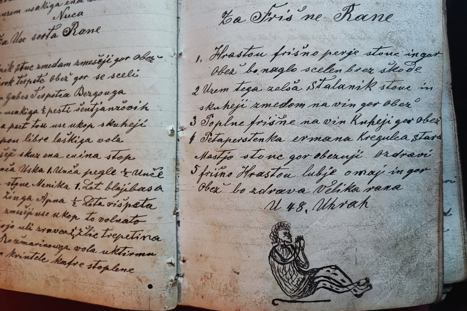 19th-century Slovenian folk-healing manuscript with remedies for fresh wounds and illustration of an injured man praying